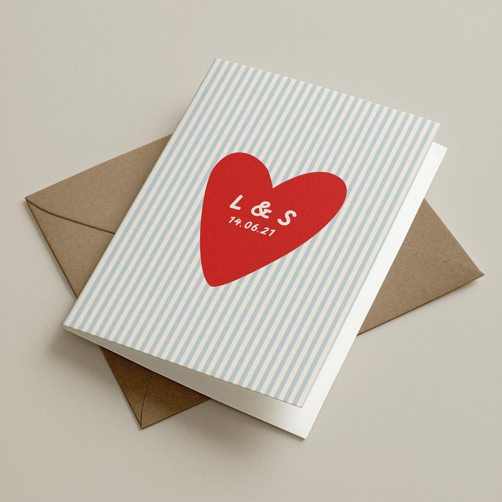 A personalized greeting card with a white and light blue striped cover, featuring a red heart with the names 'L & S' and the date '19.04.