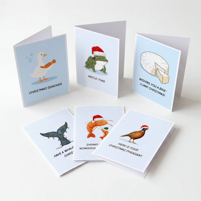 Six Christmas greeting cards arranged on a light neutral background. The cards feature humorous animal illustrations and relative puns underneath.